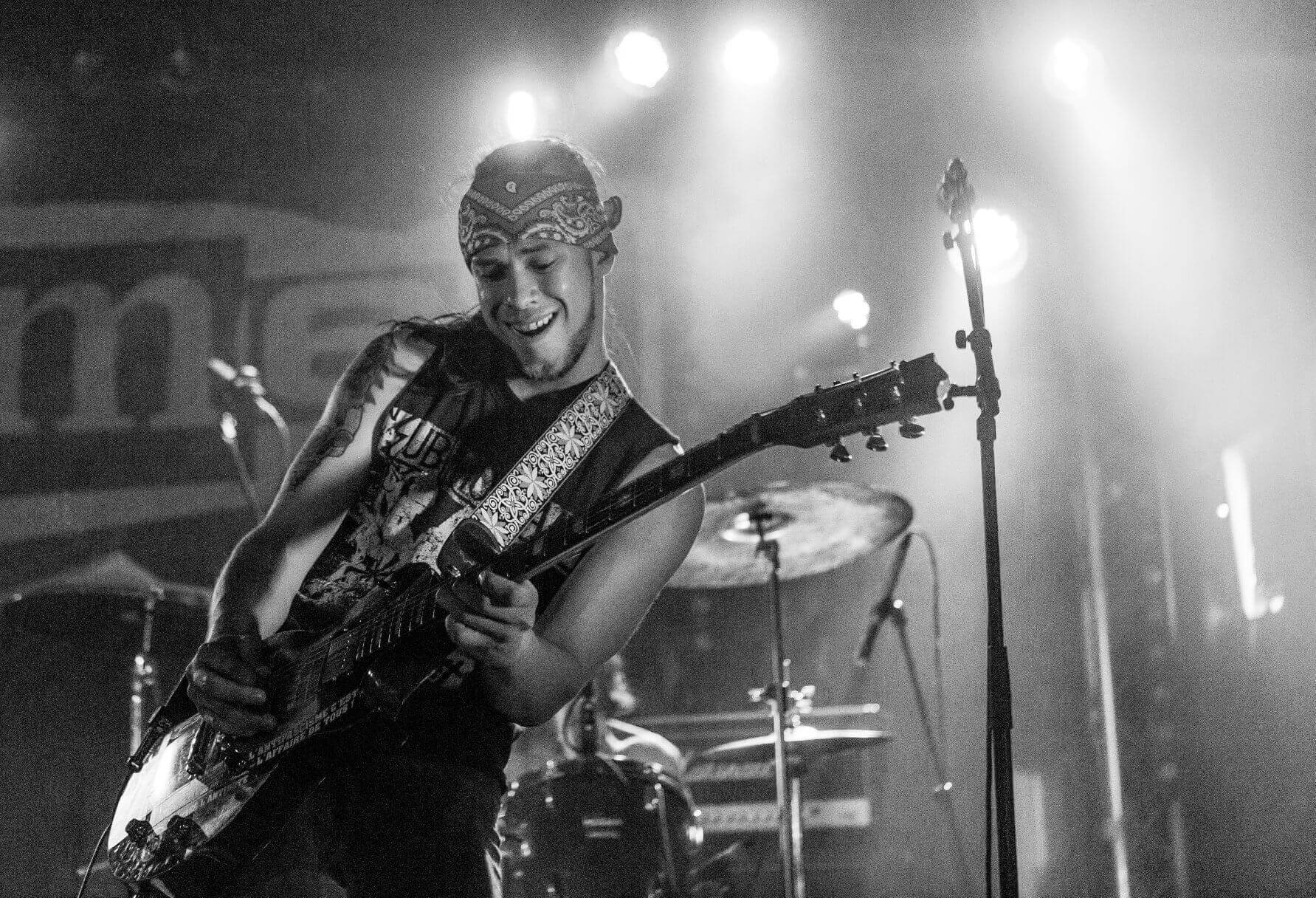  Close up photo of Abel playing guitar on stage